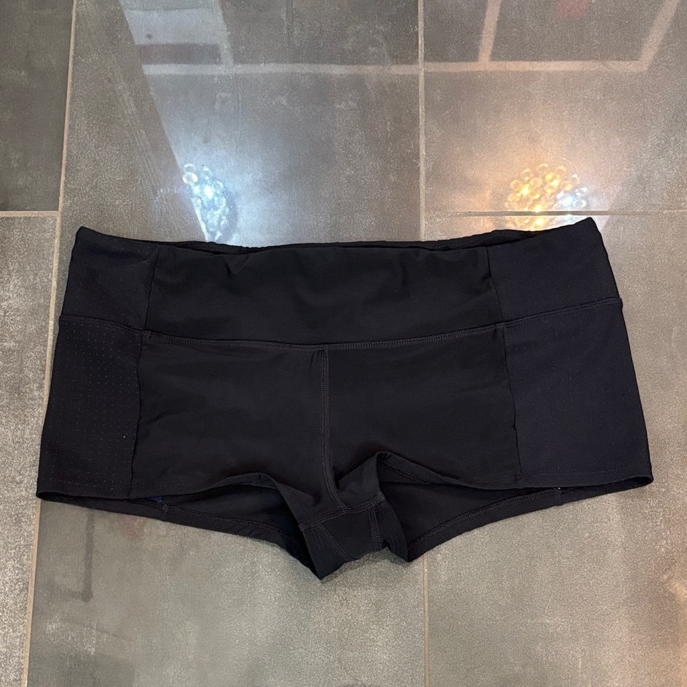 Athleta Black with perforated, edging, and blue on the inside shorts